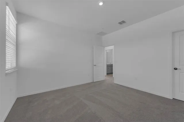 a view of an empty room and a window