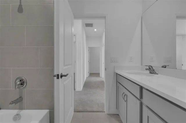 a bathroom with a granite countertop sink a toilet and shower