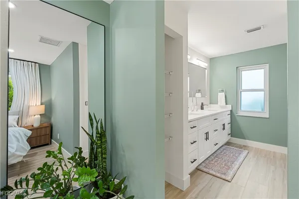 a view of hallway with sink and mirror