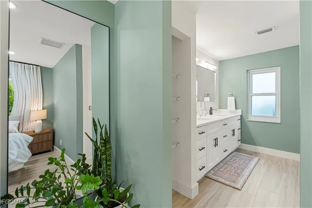 a view of hallway with sink and mirror