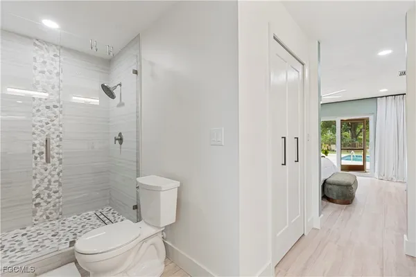 a bathroom with a toilet a sink and a shower