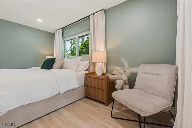 a bedroom with a bed and a chair