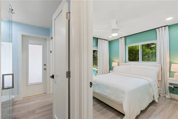 a bedroom with a large bed and a chandelier