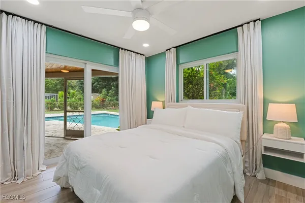 a bedroom with a large bed and a large window