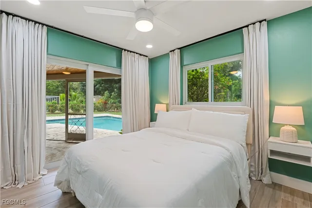 a bedroom with a large bed and a large window