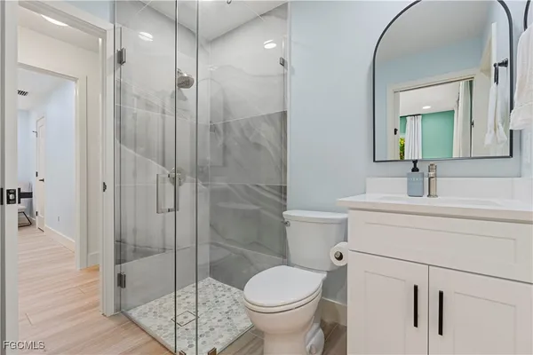 a bathroom with a toilet a sink and shower