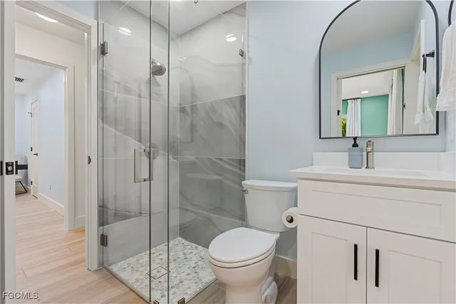 a bathroom with a toilet a sink and shower