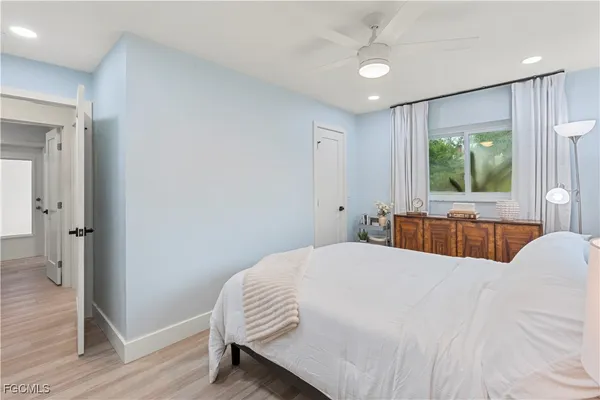 a bedroom with a large bed and a chandelier