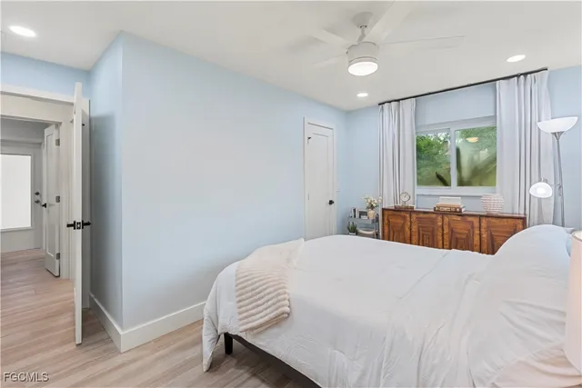 a bedroom with a large bed and a chandelier