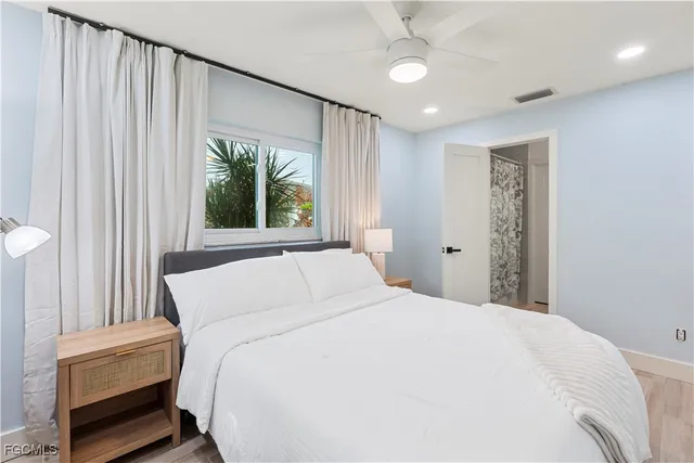 a large white bed in a white room