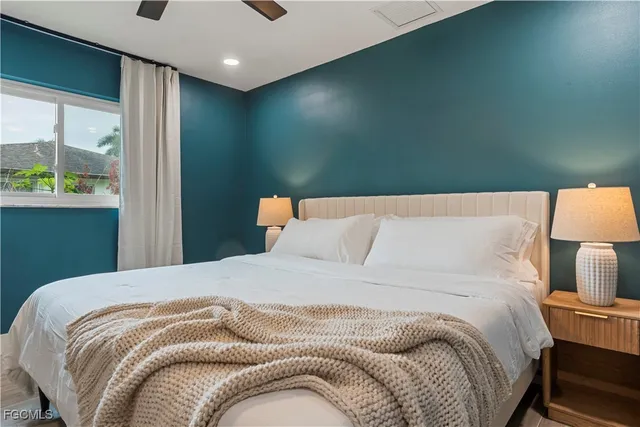 a bedroom with a bed and a night stand