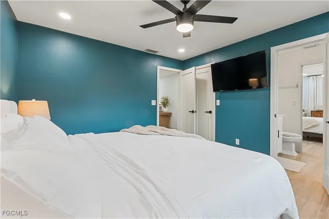 a bedroom with a bed and a flat screen tv