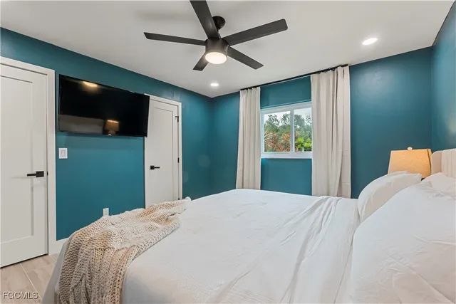 a bedroom with a large bed and a window