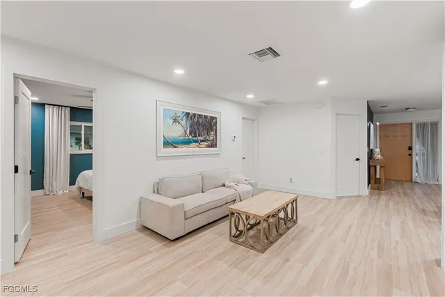 a bedroom with two beds and a dresser