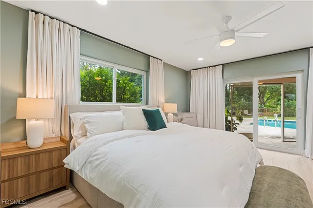 a large bedroom with a large bed and a large window with outer view