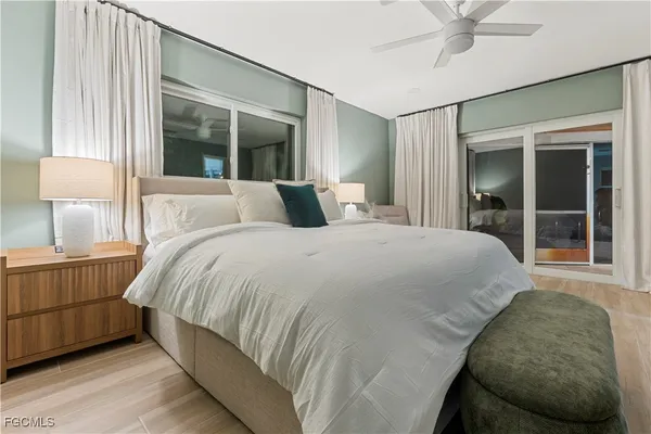 a large bed sitting in a bedroom next to a window