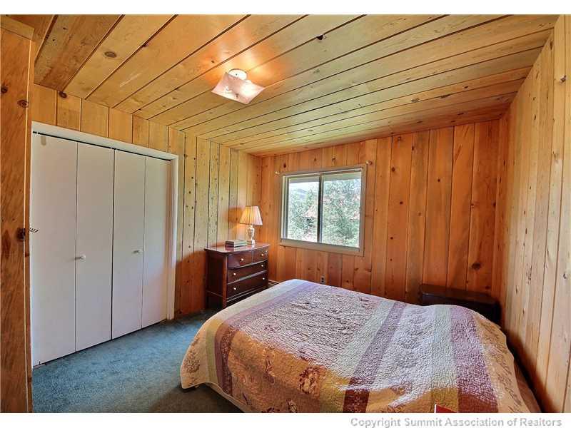 63 Idlewild Drive Summit Cove, CO 80435 - Photo 16 of 25 a bedroom with a bed and wooden floor