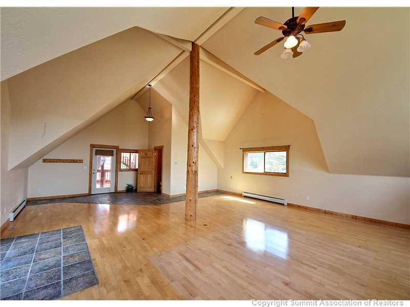 63 Idlewild Drive Summit Cove, CO 80435 - Photo 3 of 25 a view of a hallway with wooden floor and a living room