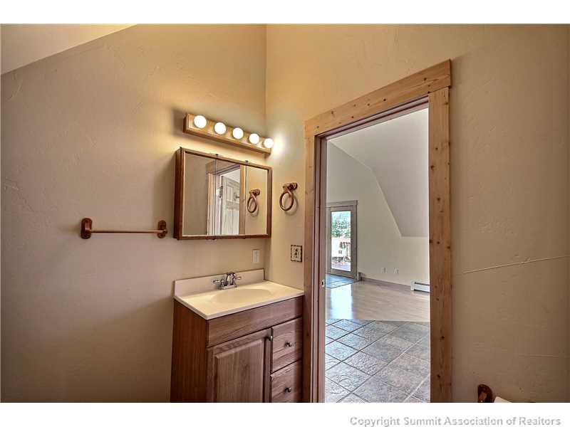 63 Idlewild Drive Summit Cove, CO 80435 - Photo 4 of 25 a bathroom with a sink mirror and vanity