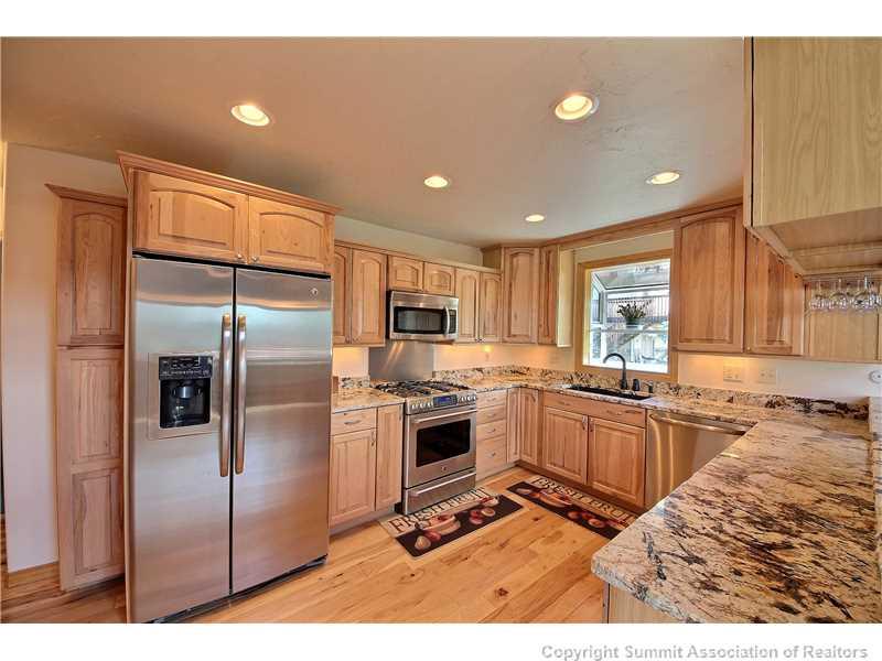 63 Idlewild Drive Summit Cove, CO 80435 - Photo 7 of 25 a kitchen with stainless steel appliances granite countertop a refrigerator a sink a stove and island