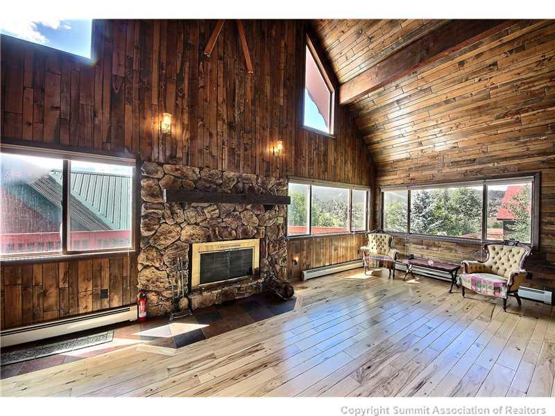63 Idlewild Drive Summit Cove, CO 80435 - Photo 8 of 25 a living room with furniture and a fireplace