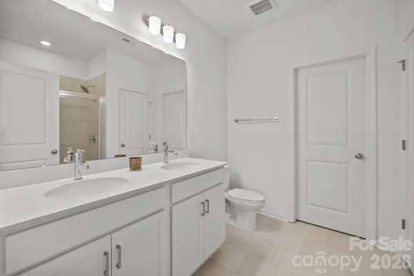 a bathroom with a shower and a sink
