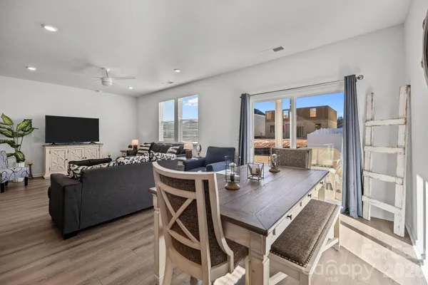 a kitchen with stainless steel appliances granite countertop a white cabinets and wooden floor