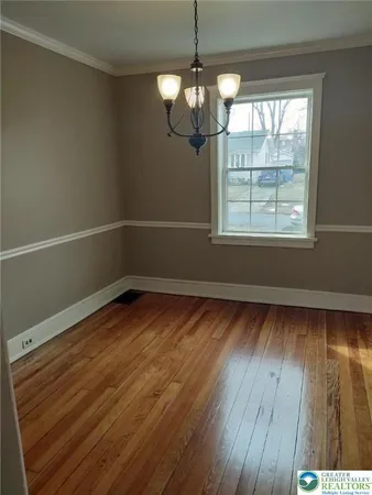 a view of a room with wooden floor and windows