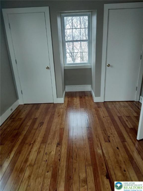 1138 Arcadia Street Bethlehem, PA 18018 - Photo 6 of 8 an empty room with wooden floor and windows