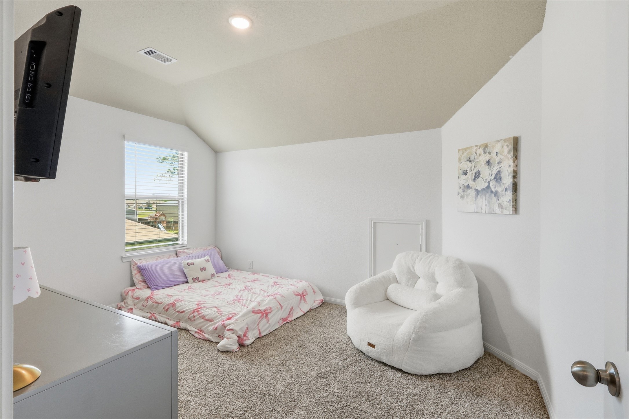 6310 Fawn Path Drive Conroe, TX 77303 - Photo 27 of 41 Spacious upstairs secondary bedroom featuring neutral designer colors, abundant natural light, and a versatile layout to fit any lifestyle.