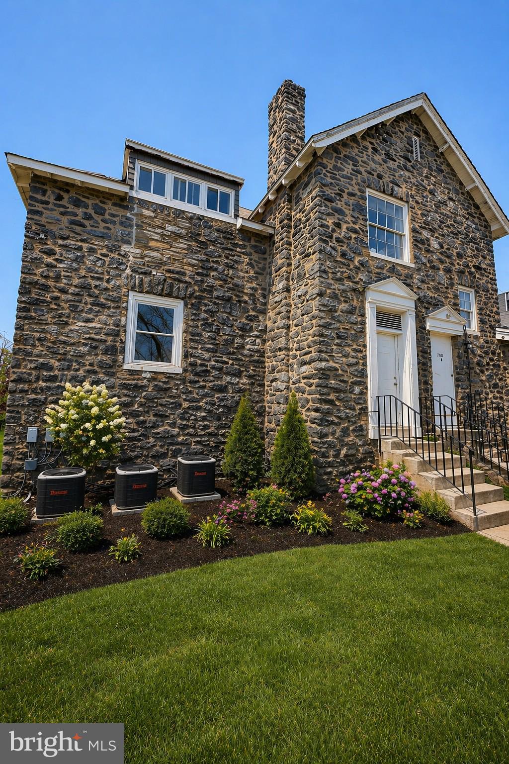 a front view of a house with a garden