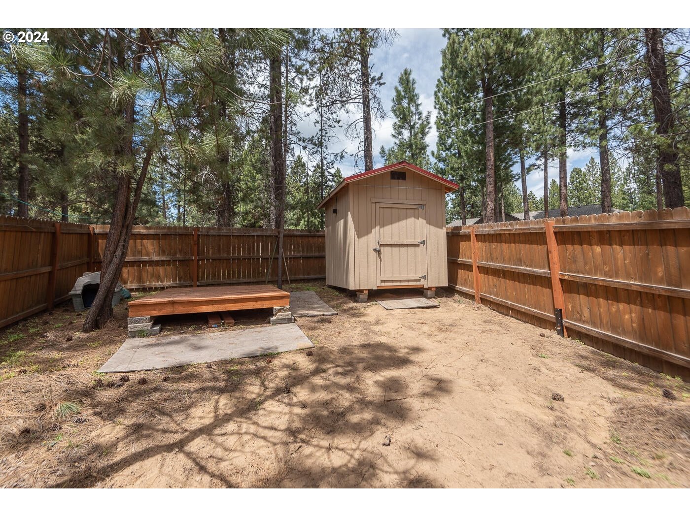 16942 Downey Road Bend, OR 97707 - Photo 20 of 22 a view of backyard with wooden fence and trees
