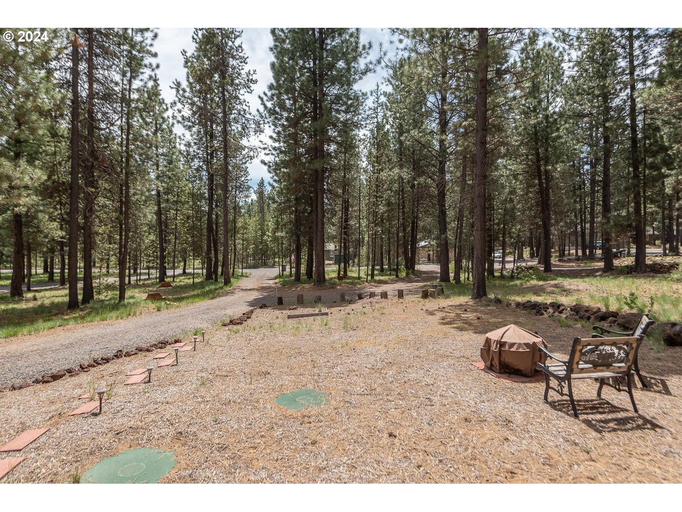 16942 Downey Road Bend, OR 97707 - Photo 21 of 22 a backyard of a house with table and chairs