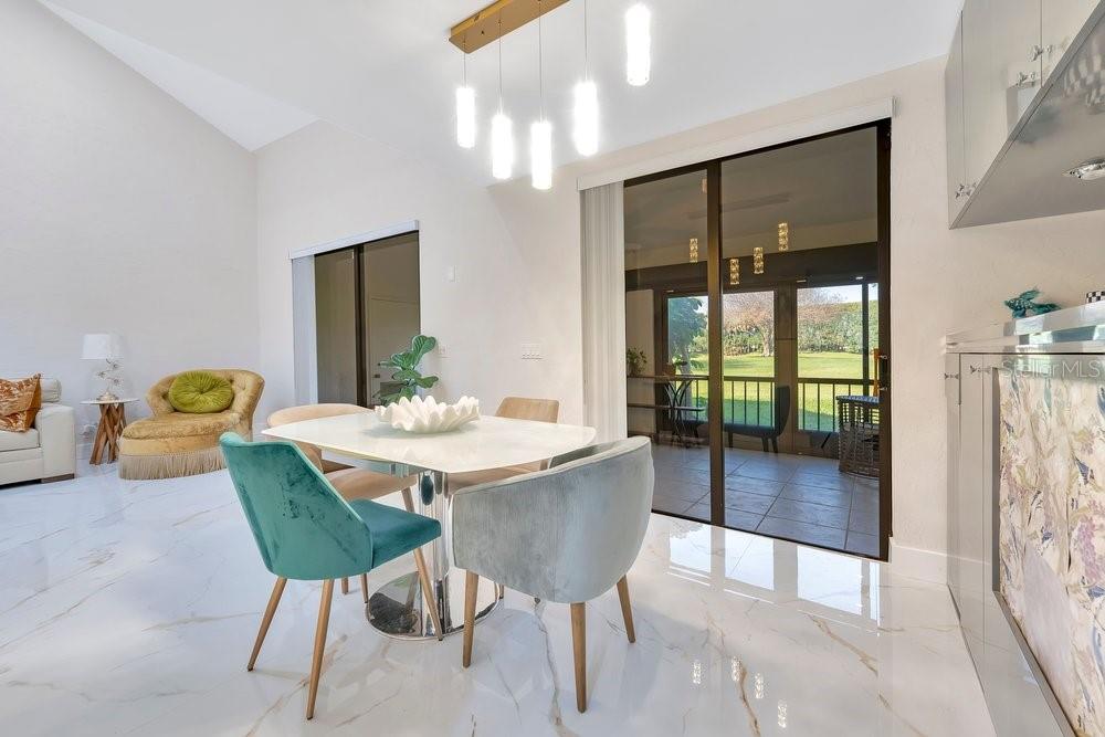 7838 La Mirada Drive Boca Raton, FL 33433 - Photo 15 of 43 a view of a dining room with furniture and a chandelier