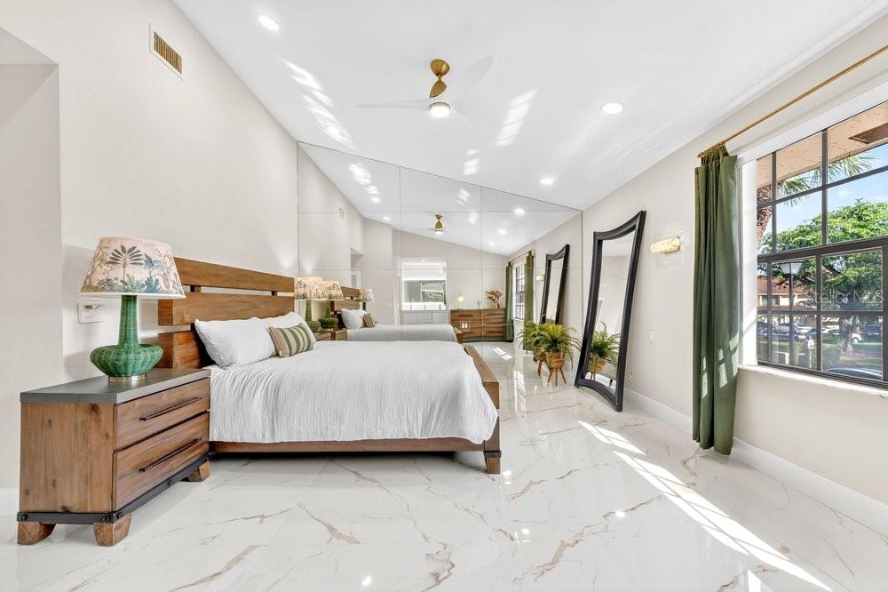 7838 La Mirada Drive Boca Raton, FL 33433 - Photo 25 of 43 a spacious bedroom with a bed and large windows