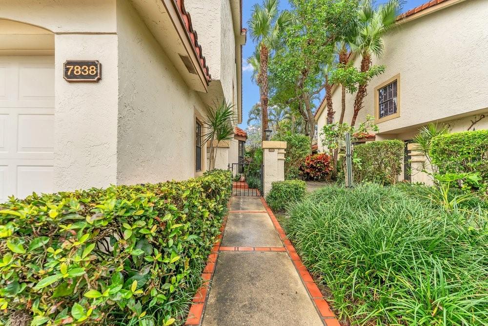 7838 La Mirada Drive Boca Raton, FL 33433 - Photo 3 of 43 a view of a pathway with house on both side