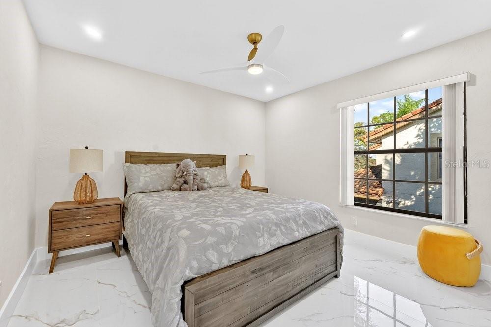 7838 La Mirada Drive Boca Raton, FL 33433 - Photo 32 of 43 a bedroom with a bed and a couch