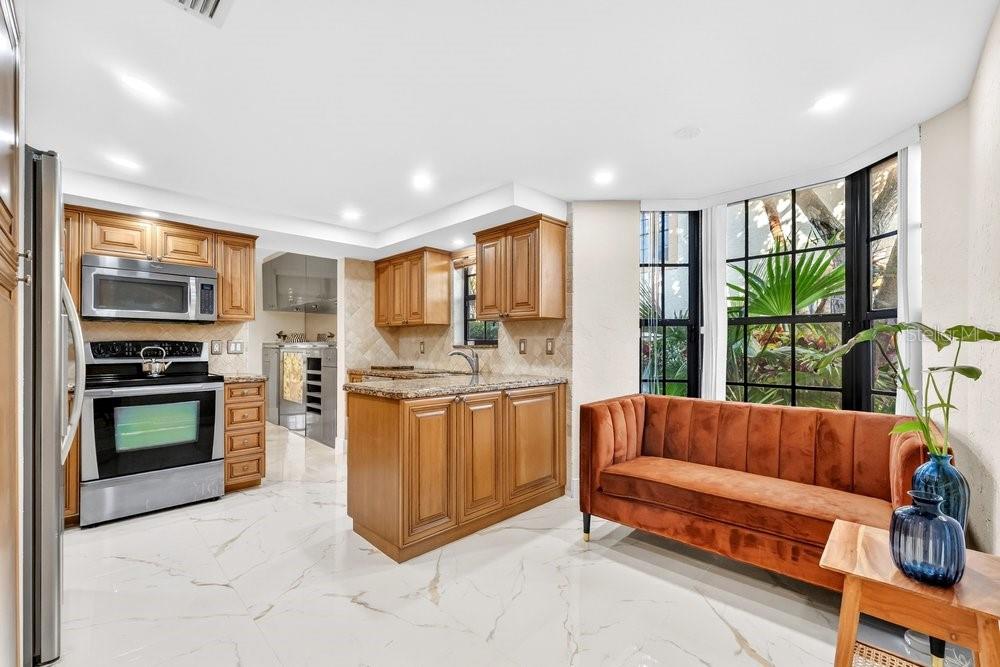 7838 La Mirada Drive Boca Raton, FL 33433 - Photo 9 of 43 a living room with stainless steel appliances furniture a flat screen tv and a kitchen view