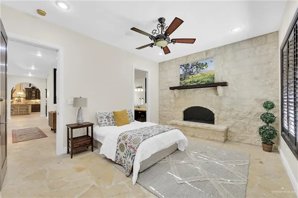 a bedroom with a bed and a fireplace