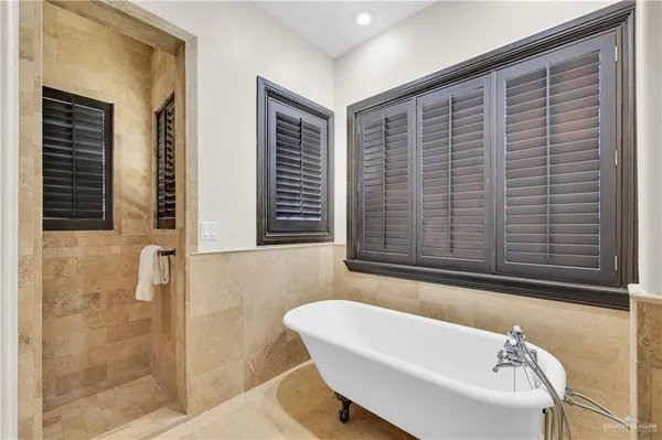 a bathroom with a bathtub and shower
