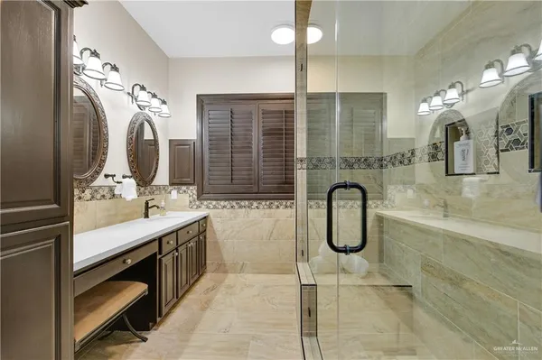 a bathroom with double vanity sink and a mirror