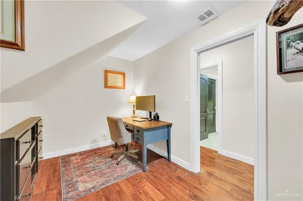 a workspace with furniture and a wooden floor