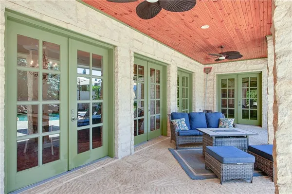 a building outdoor space with patio furniture and potted plants