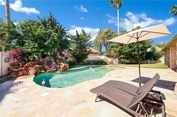 a front view of a house with swimming pool having outdoor seating