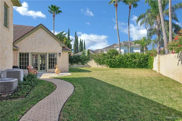 a view of a house with backyard and sitting area