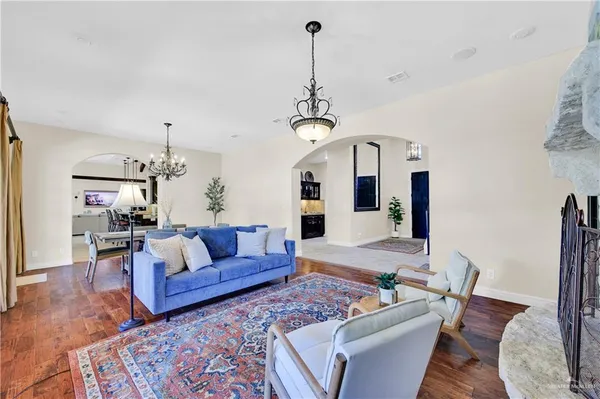 a living room with furniture and a chandelier