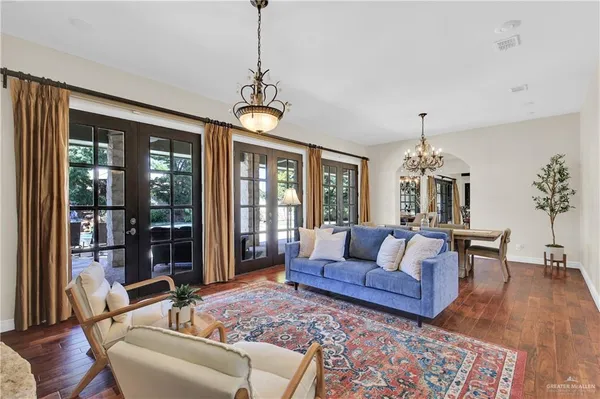 a living room with furniture a chandelier and a table