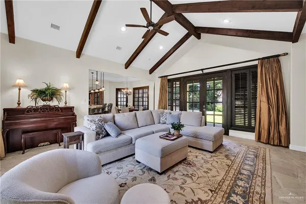 a living room with furniture and a floor to ceiling window
