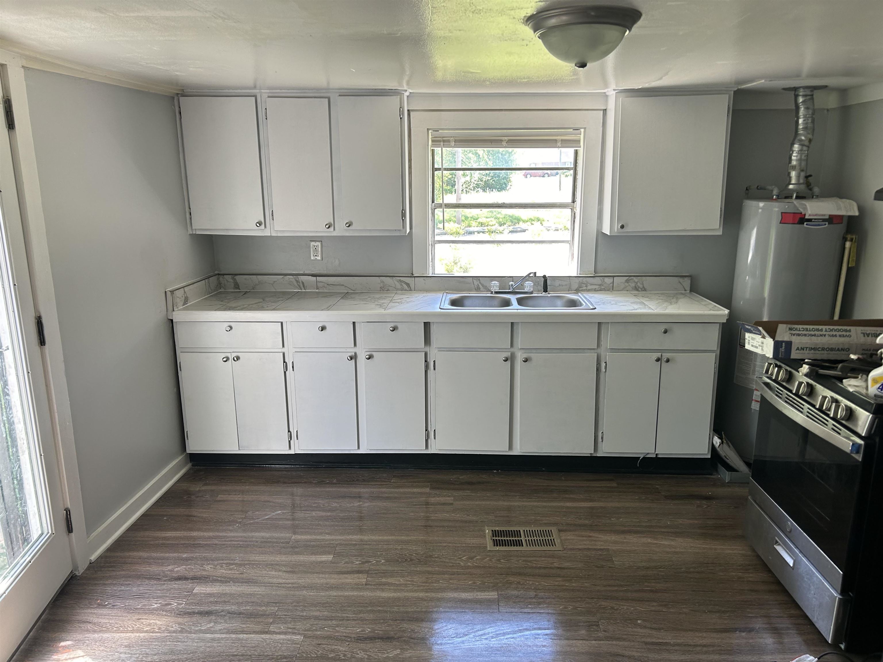 3030 Alta Road Memphis, TN 38109 - Photo 2 of 6 a kitchen with granite countertop a sink cabinets and wooden floor