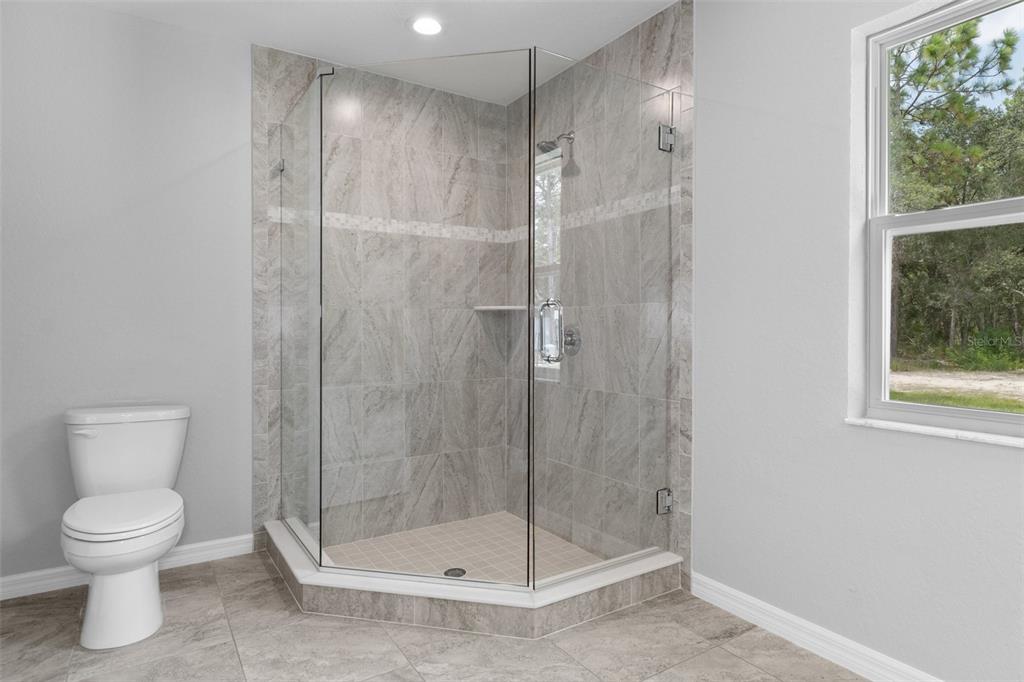 16375 Kakawi Road Brooksville, FL 34614 - Photo 19 of 30 a bathroom with a shower a toilet and a sink